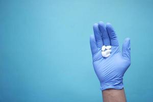 single medical pills on palm of hand , top view photo