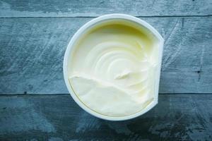 fresh butter in a container with bread on white background photo