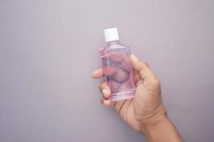 hand hold a mouthwash liquid container photo