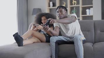 Father and daughter having fun playing console games on vacation day. Daughter is very happy after winning. Holiday family activities concept. video