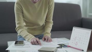 The woman scans to pay online. Women are using mobile app to check expenses and open and view expense details via QR code. Concept of management via internet system. video