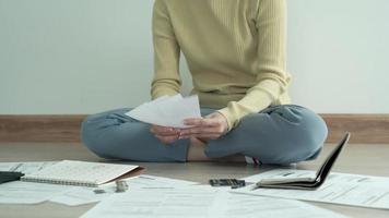 Debt credit and financial problem concept. Asia woman is sitting and recheck on invoices and stress because not manage debt on month. woman covering face with hands and feel stressed. video