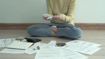 Debt credit and financial problem concept. Asia woman is sitting and recheck on invoices and stress because not manage debt on month. woman covering face with hands and feel stressed. video