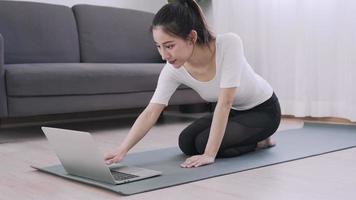 Slim Asia woman practicing yoga on condo. beautiful female doing exercises in morning. balance, recreation, relaxation, calm, good health, happy, relax, healthy lifestyle, reduce stress, peaceful. video