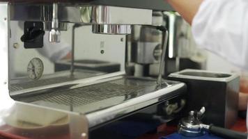 barista prepare coffee before brew coffee. owner of a small coffee shop is brewing coffee with coffee beans for serve to the customers. New Barista for coffee maker. video