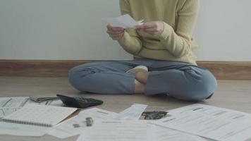 Debt credit and financial problem concept. Asia woman is sitting and recheck on invoices and stress because not manage debt on month. woman covering face with hands and feel stressed. video