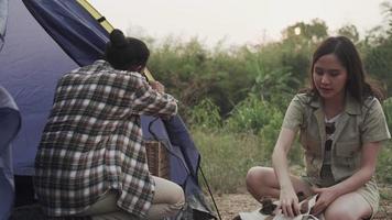 um casal vai acampar na floresta com a esposa ajudando a entregar suas malas e pertences. casal fazendo turismo de natureza nas férias. conceito de turismo de distância social. video