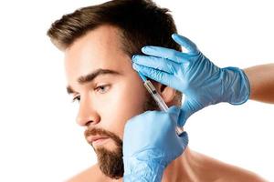 Man receiving scalp injection for hair grow photo