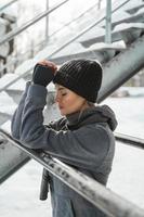 Young athletic woman during her winter workout outside photo