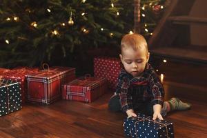 Little boy wearing checkered shirt at home during Christmas eve. photo