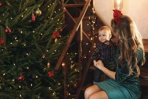 Happy mother and her cute little son are celebrating Christmas or New year. photo