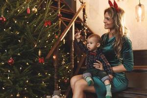 Happy mother and her cute little son are celebrating Christmas or New year. photo