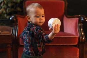 Little boy wearing checkered shirt at home during Christmas eve. photo