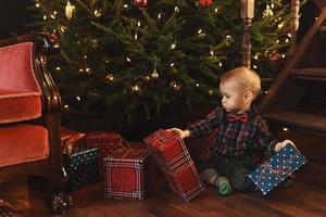 Little boy wearing checkered shirt at home during Christmas eve. photo