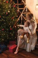 Happy mother and her cute little son are celebrating Christmas or New year. photo