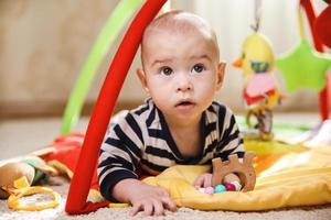 Cute baby is playing on the activity mat photo