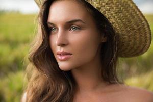 Young and lovely woman wearing straw hat photo