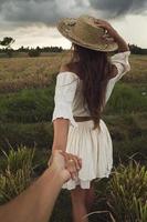 Couple holding hands in the rice field photo