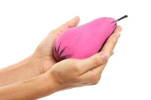 Female hand and creatively decorated pink pear photo