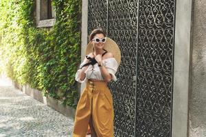 Young woman walking by the streets of small Italian town photo