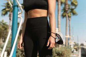 Woman with facial mask during her summer street workout photo