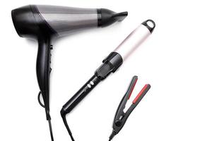 Different electronic tools for hair styling on white photo