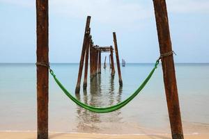 Hammock hanging on old beams from the broken pier photo