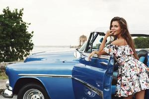 Beautiful woman driving a retro convertible car photo