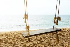 Wooden swing with view to the sea photo