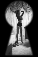 Watching through the keyhole on woman wearing lingerie photo