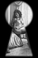 Watching through the keyhole on woman wearing lingerie photo