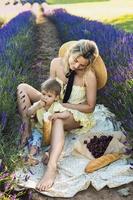 Beautiful woman and her cute little son in the lavender field photo