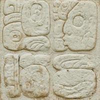 Ancient Maya script carved on the stone wall photo