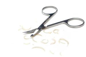 Manicure scissors and nail clipping on white background photo