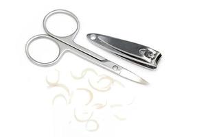 Manicure scissors, clipper and dirty nails on white background photo