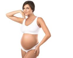 Young and beautiful pregnant woman on white background photo