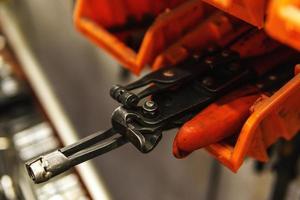 Different tools in repair shop. Hose clamps pliers. photo