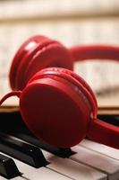 Closeup of red headphones over synthesizer keyboard photo