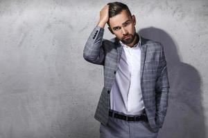 Handsome bearded man wearing gray checkered suit photo