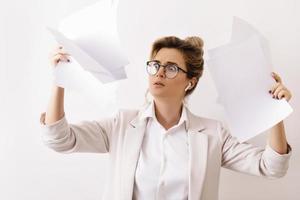 Tired businesswoman with a lot of paper documents photo