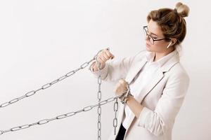 Tired business woman is pulling the chains photo