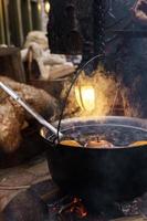 Bowl with a mulled wine on the open fire photo