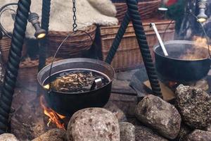 Bowl with a mulled wine on the open fire photo