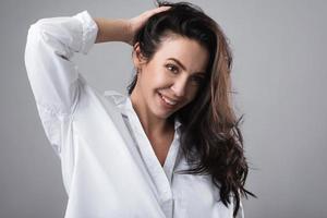 Portrait of beautiful middle aged woman wearing white shirt photo