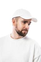 hombre guapo con gorra blanca en blanco sobre fondo blanco foto