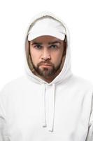 Handsome man wearing blank white cap and hoodie on white background photo