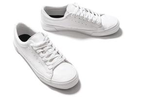 Pair of white leather trainers on white background photo