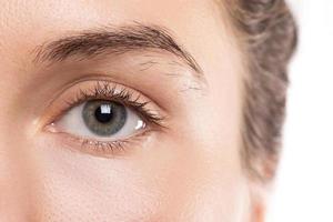 Closeup of female face with unkempt and unruly eyebrow photo