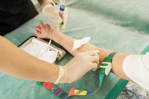 Nurse collecting patient's blood sample for test or donation photo