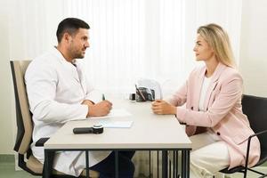 Doctor and female patient during consultation photo